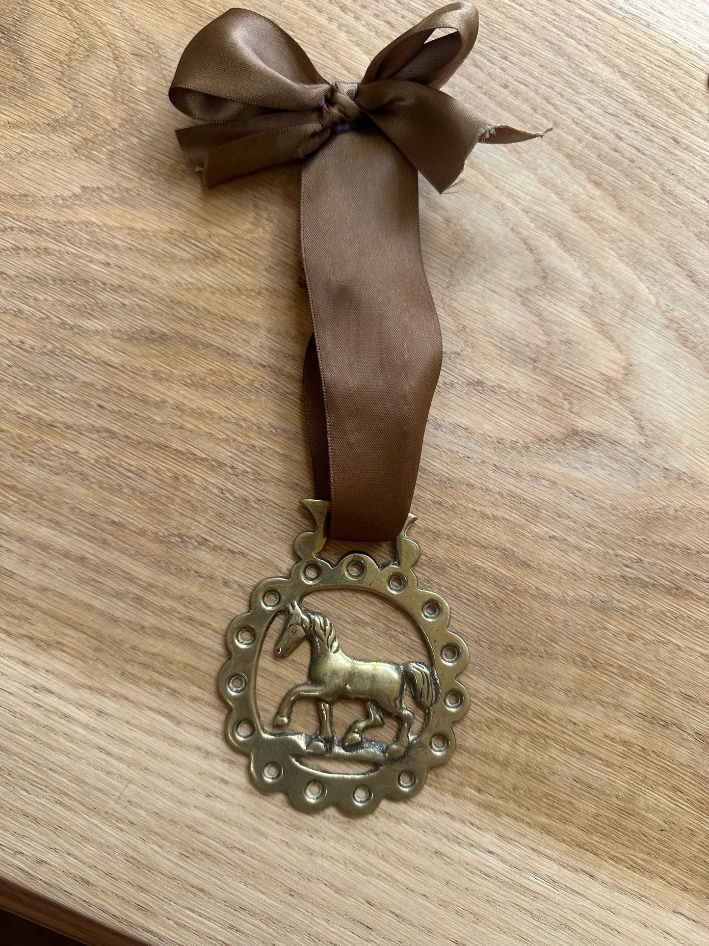 vintage brass token on bow ribbon
