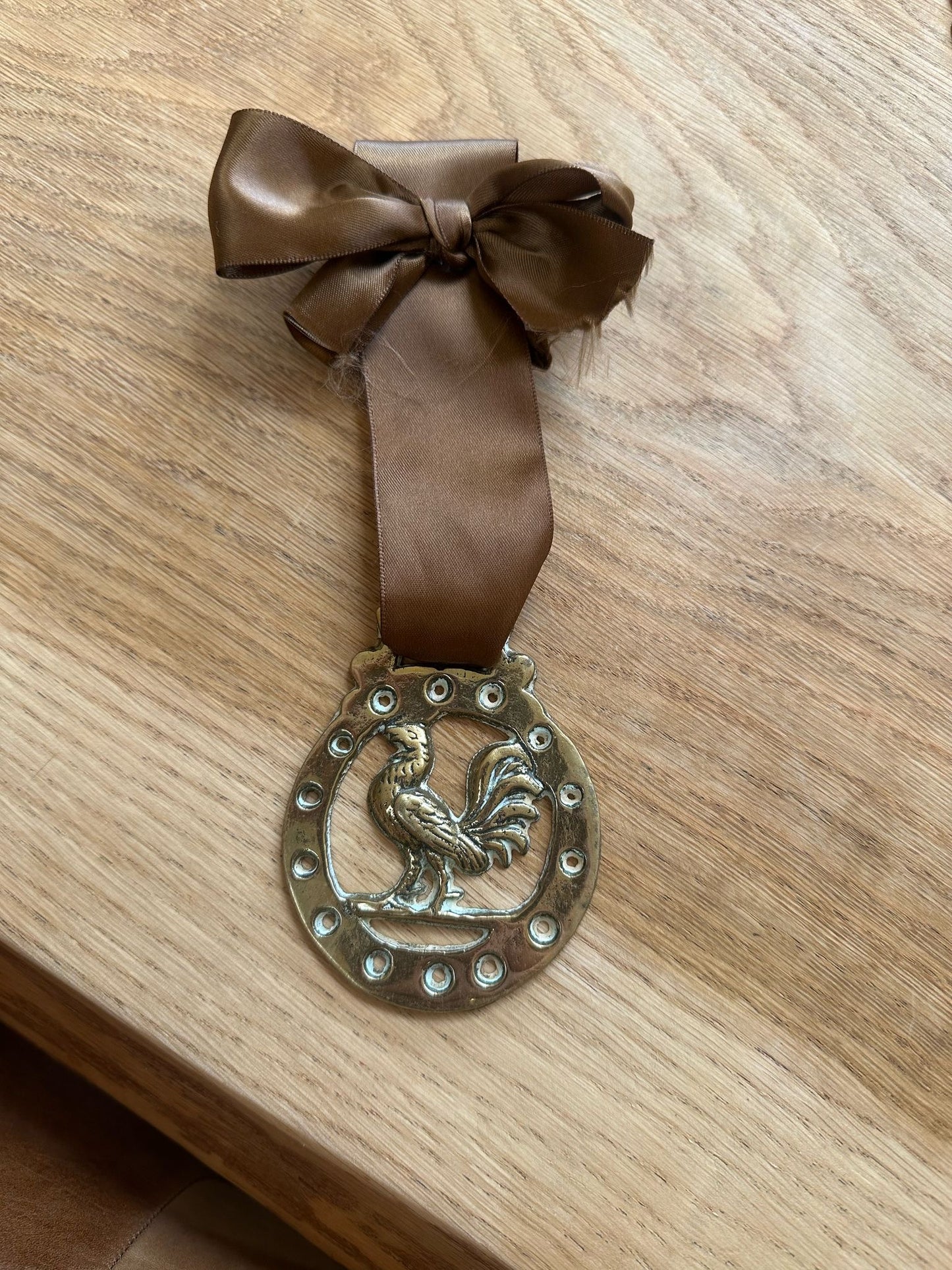 vintage brass token on bow ribbon
