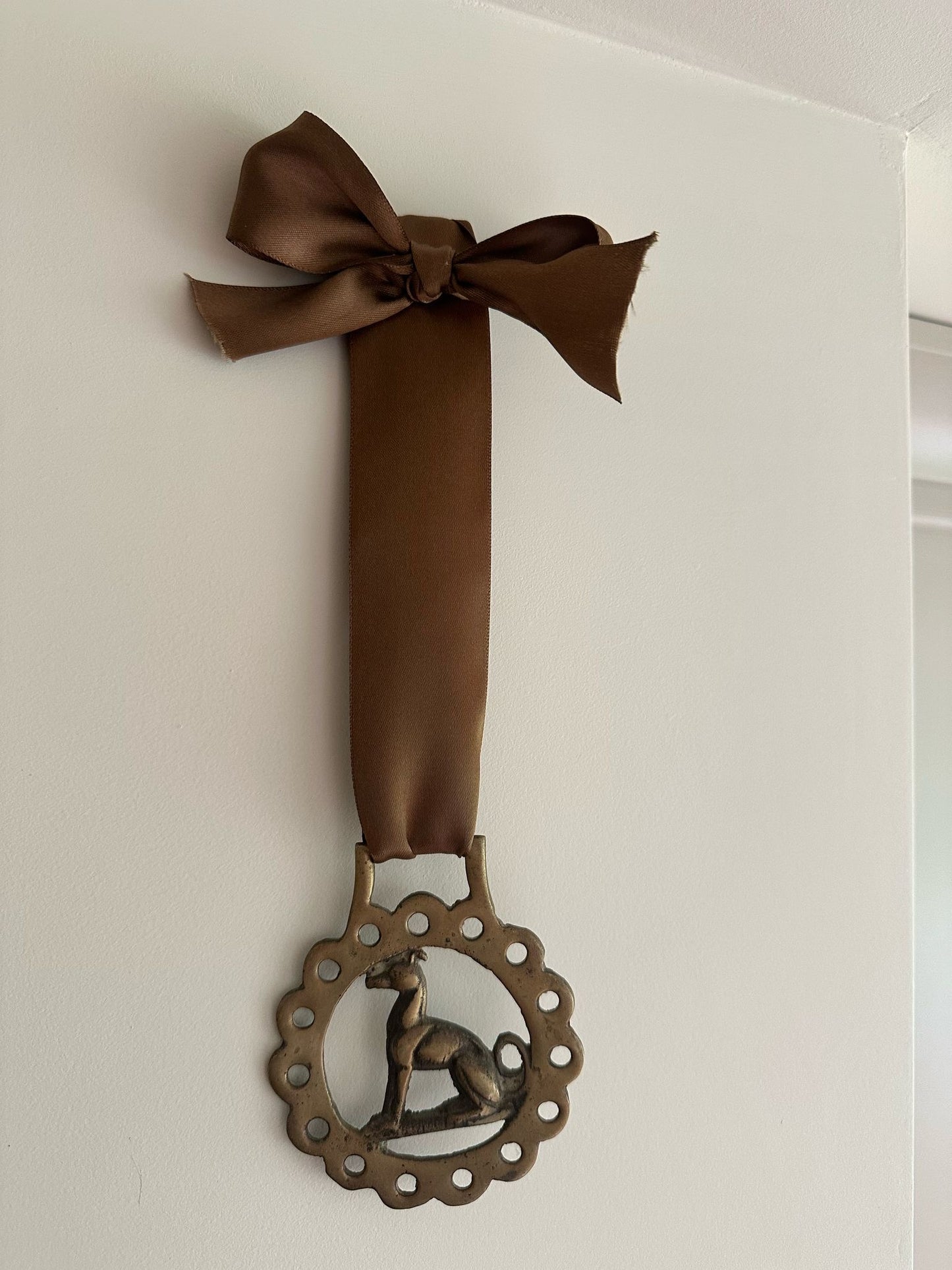 vintage brass token on bow ribbon