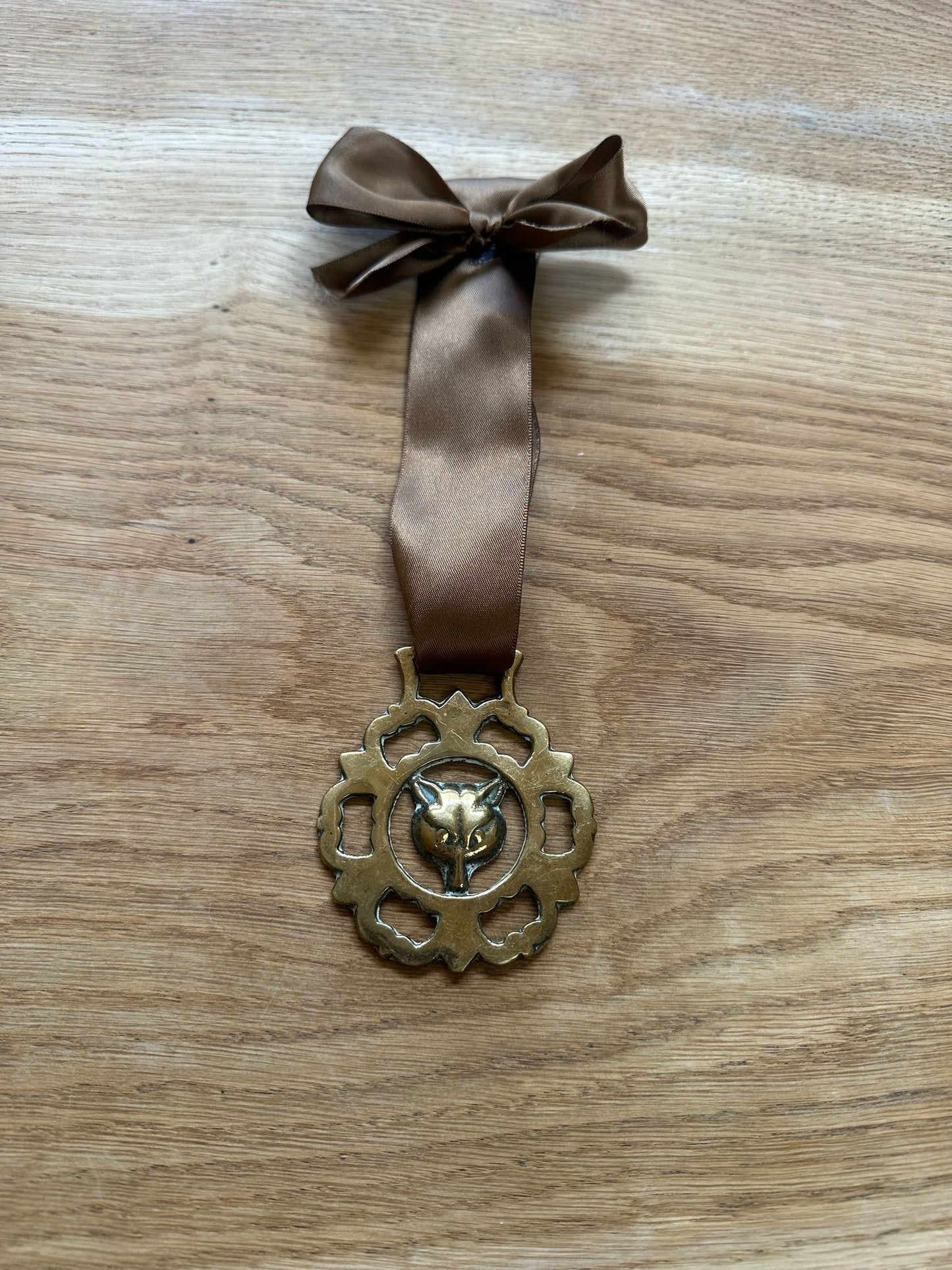 vintage brass token on bow ribbon