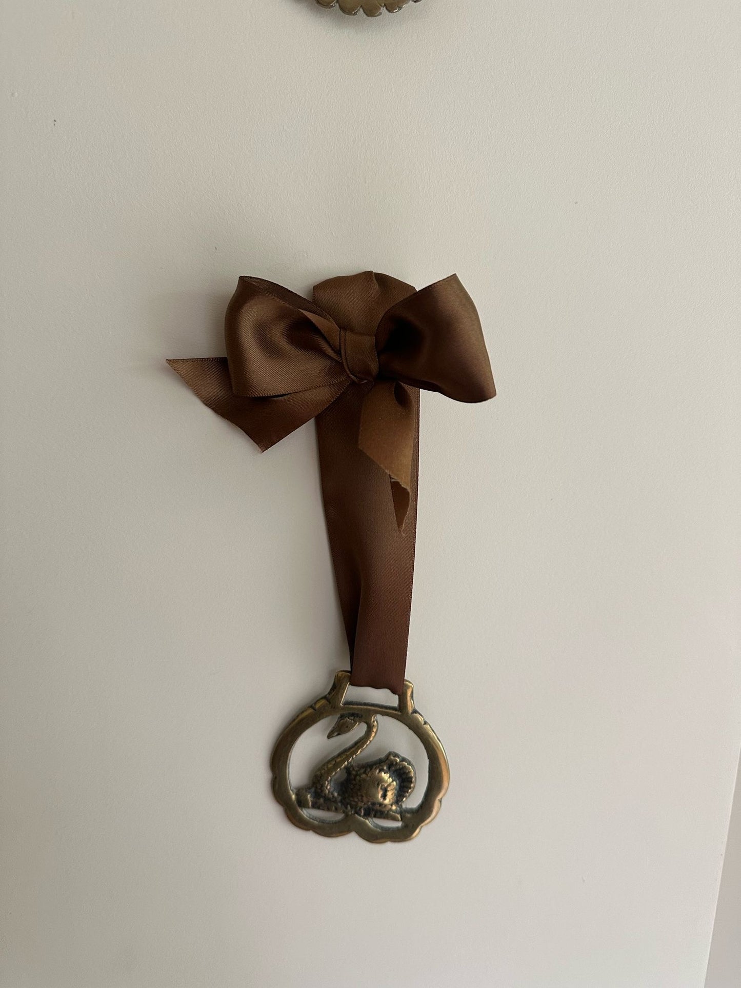 vintage brass token on bow ribbon