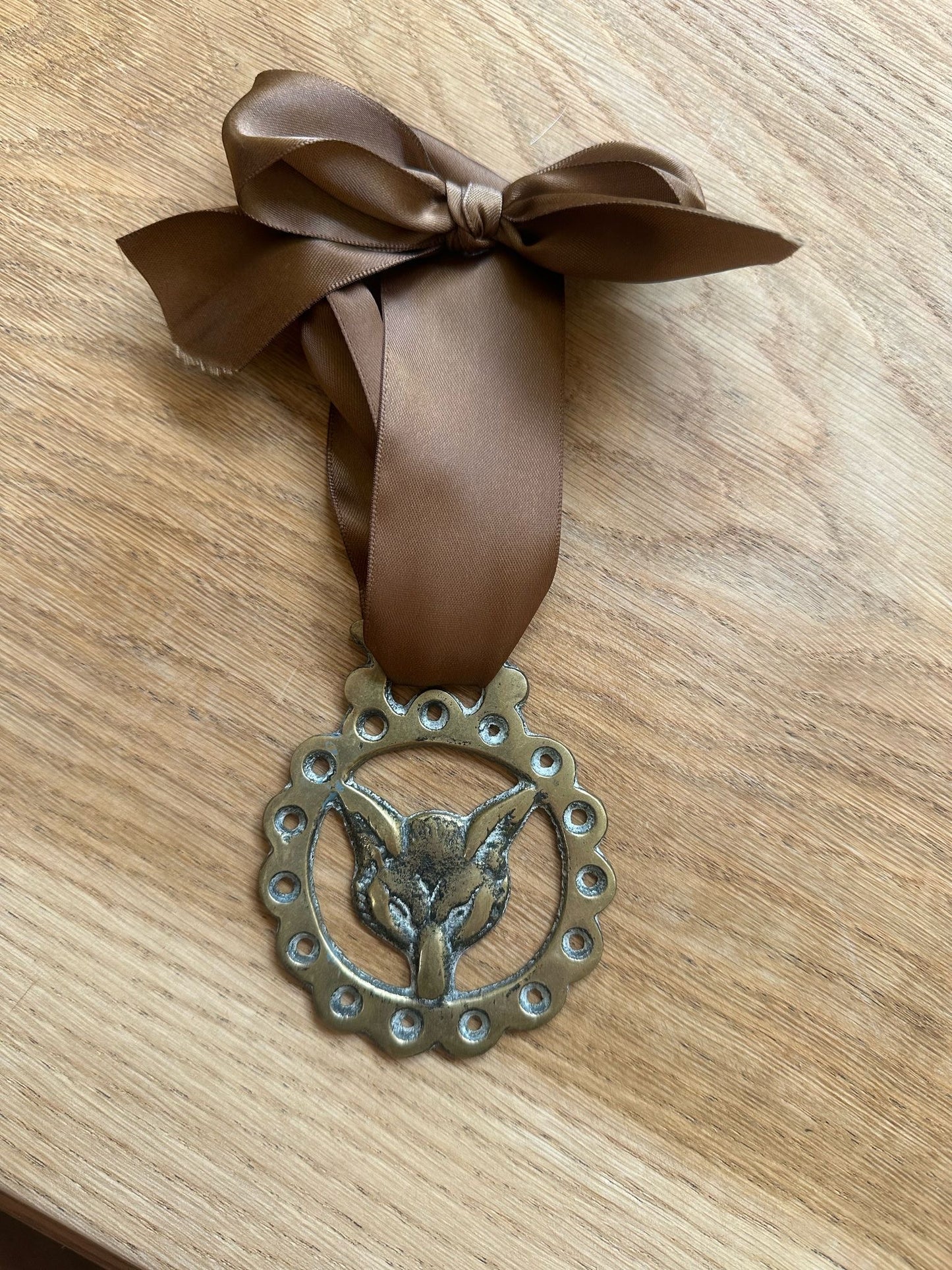 vintage brass token on bow ribbon