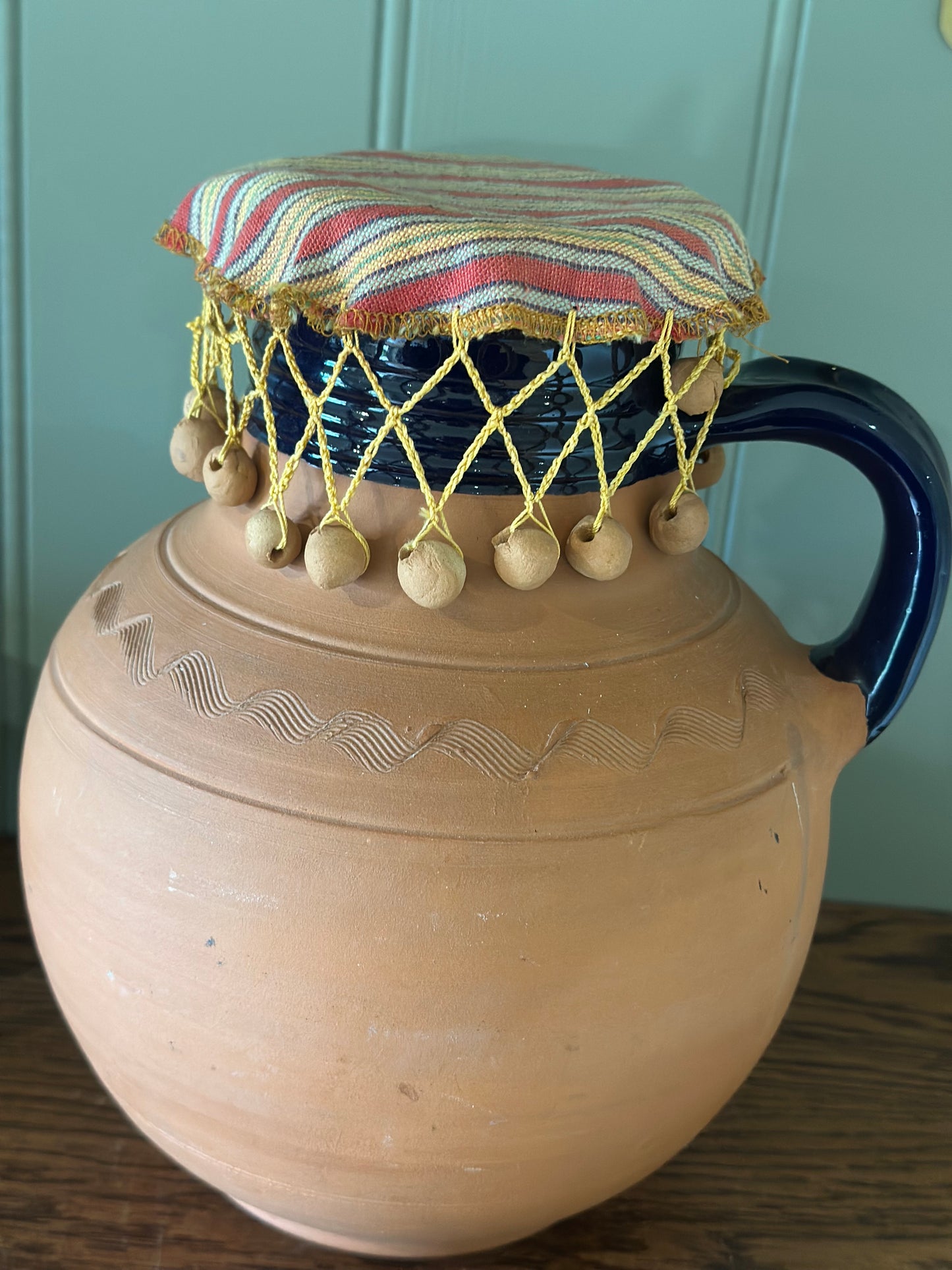 Vintage Greek water wine jug with material beaded lid
