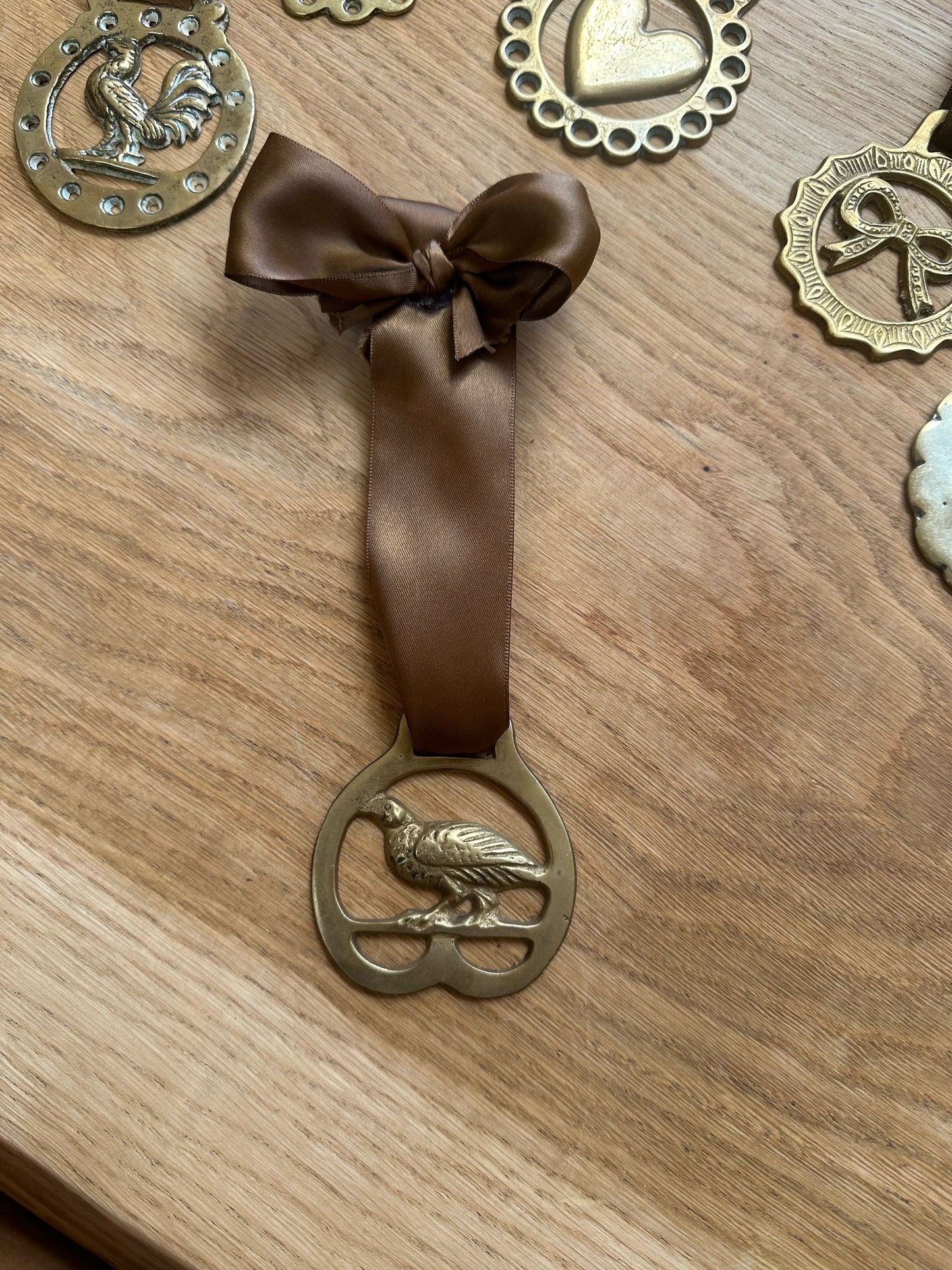 vintage brass token on bow ribbon