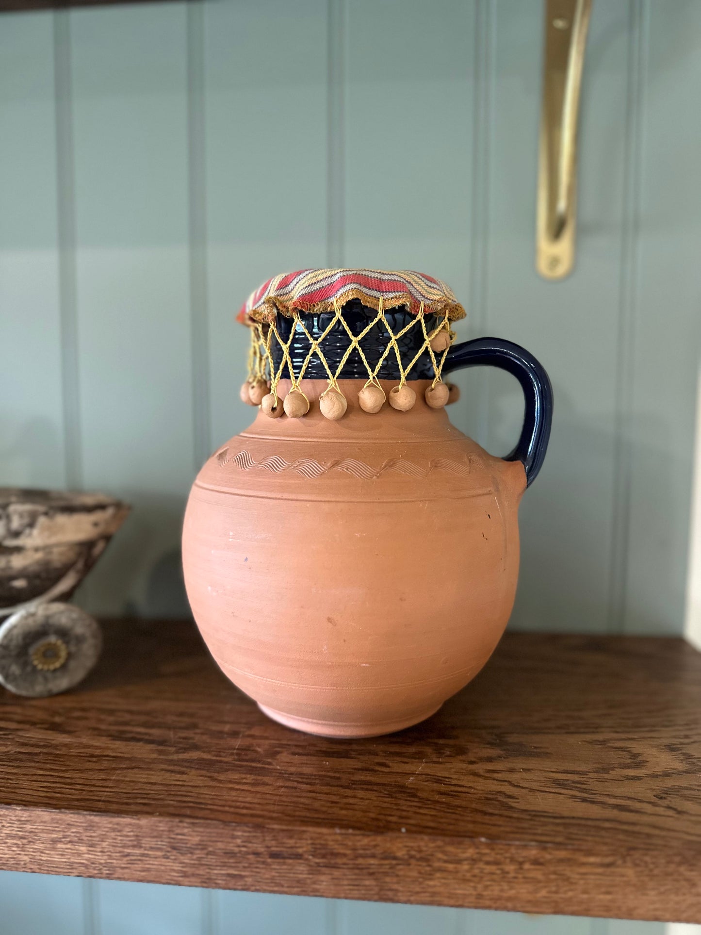 Vintage Greek water wine jug with material beaded lid