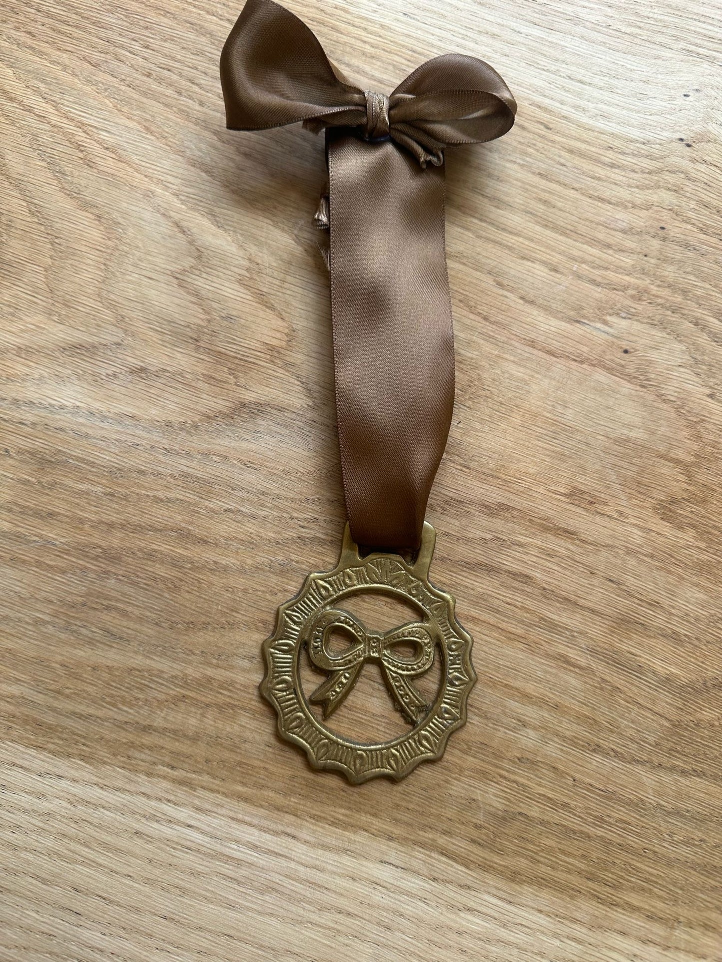 vintage brass token on bow ribbon