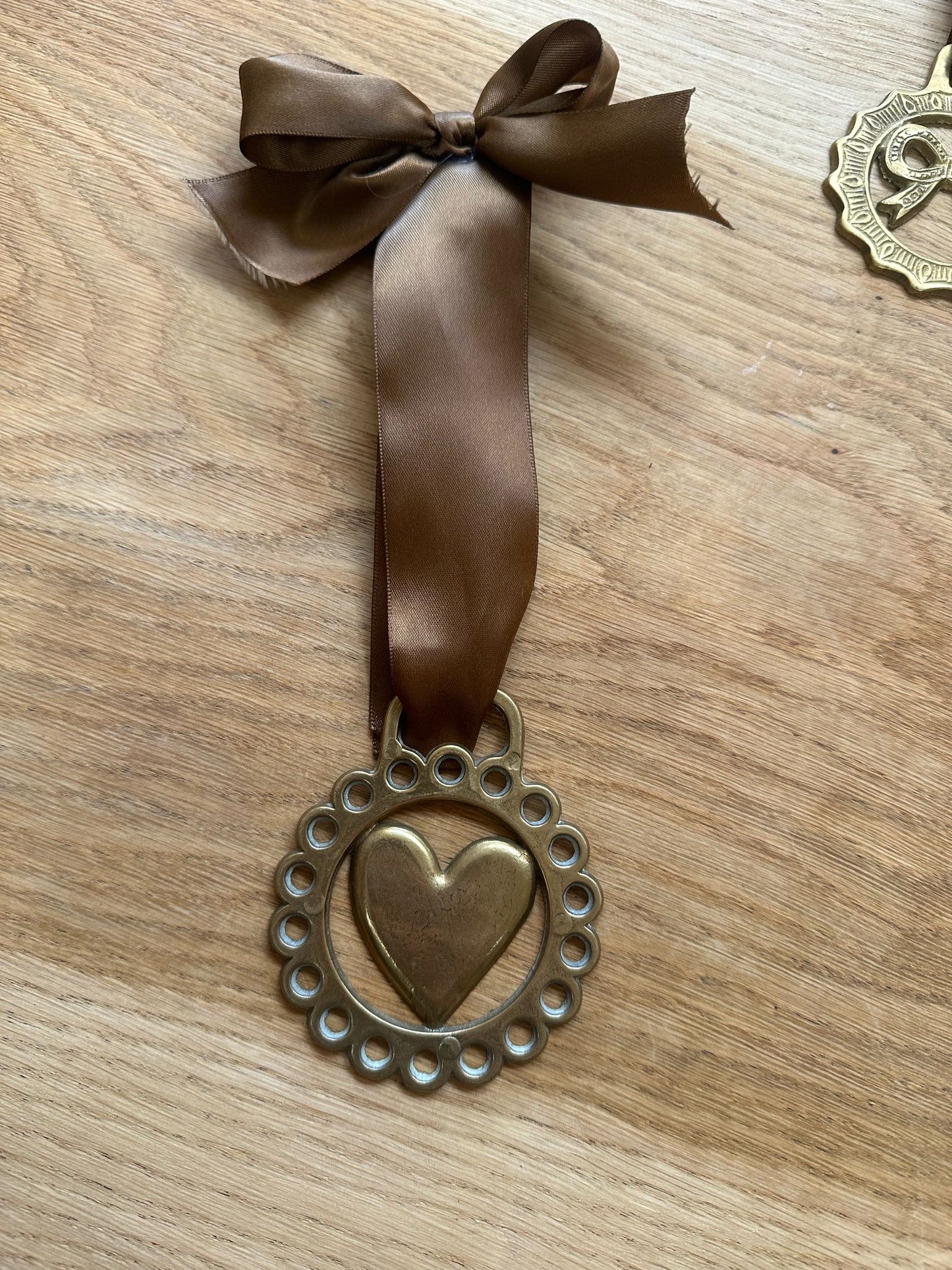 vintage brass token on bow ribbon