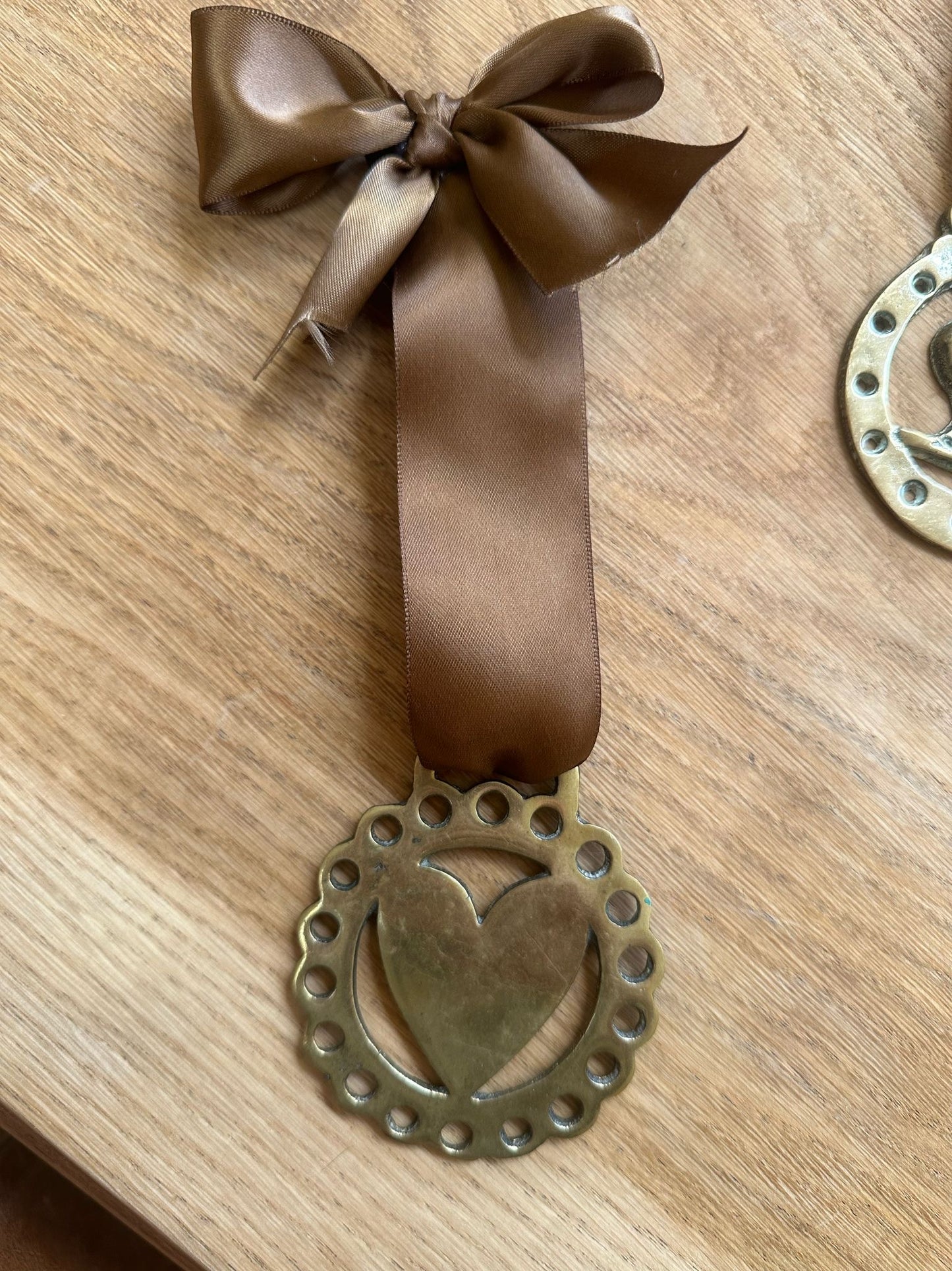 vintage brass token on bow ribbon