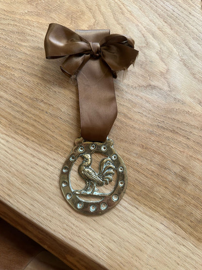vintage brass token on bow ribbon