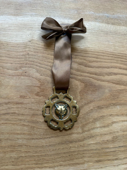 vintage brass token on bow ribbon