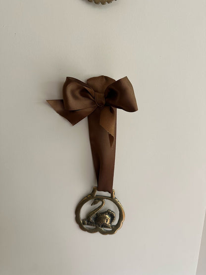 vintage brass token on bow ribbon