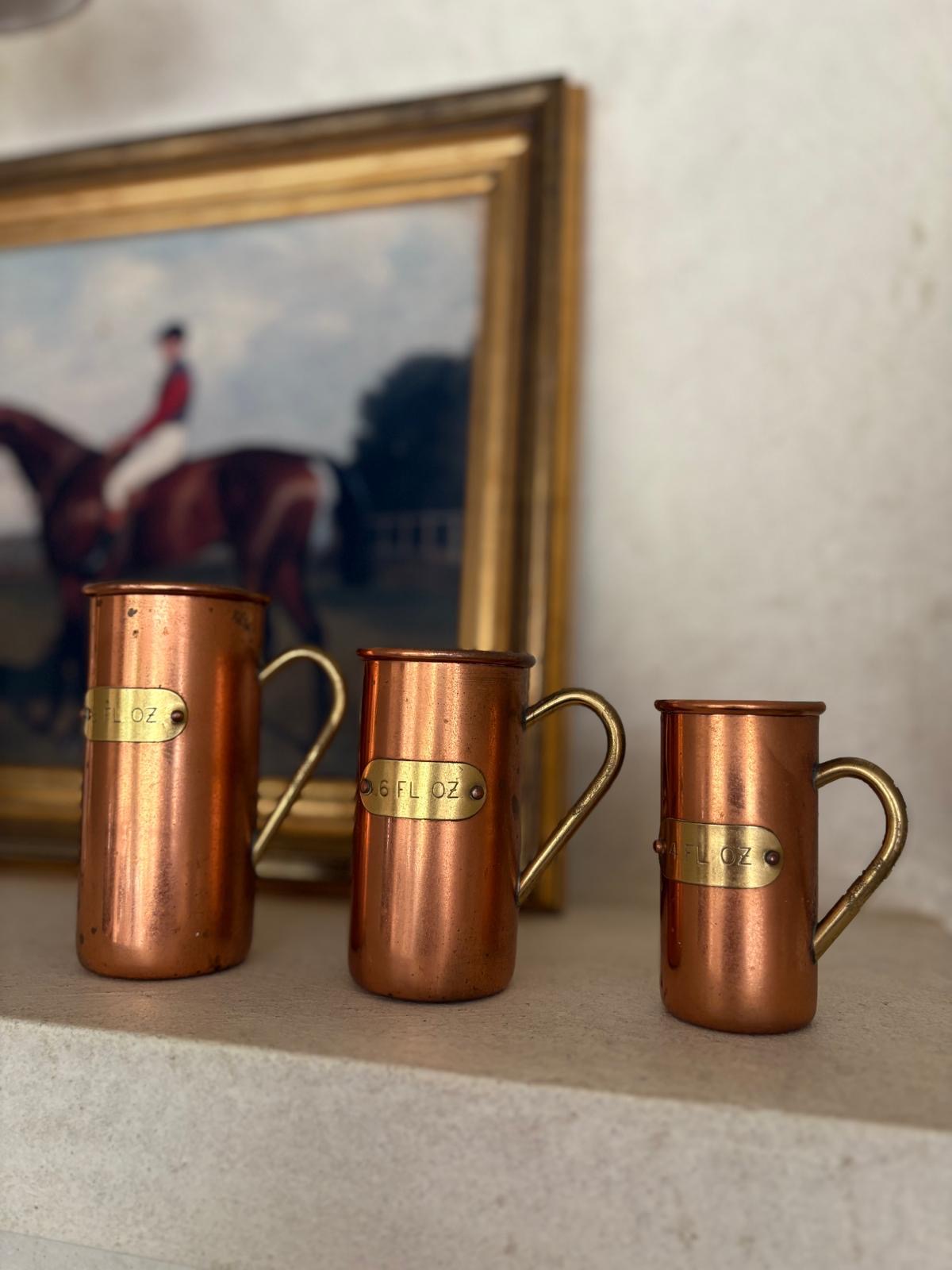 Vintage copper & brass measuring cups shelf styling