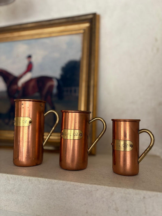 Vintage copper & brass measuring cups shelf styling
