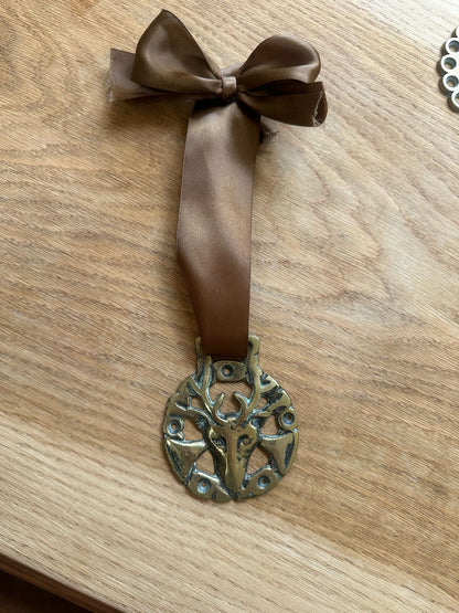 vintage brass token on bow ribbon