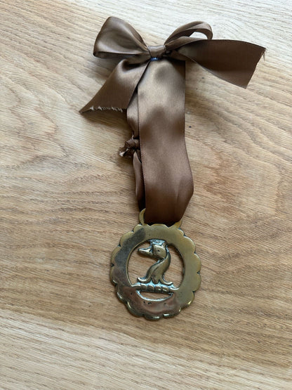 vintage brass token on bow ribbon